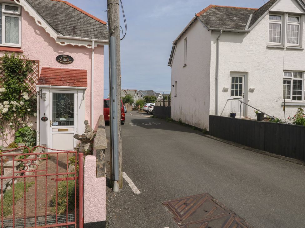 A street view of two residential houses with a gate at Bay View in Brixham