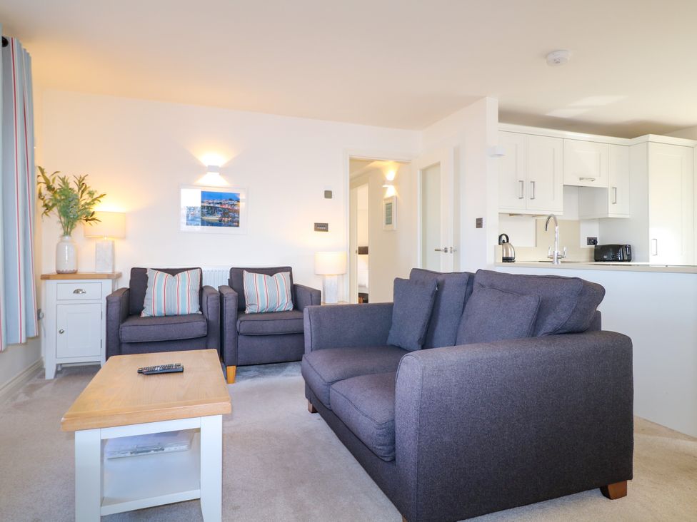 A living room with furniture and a picture at Bay View in Brixham