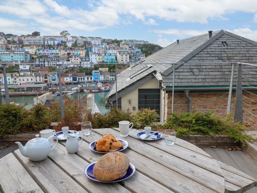 An outdoor dining setup with tea and pastries at Bay View in Brixham