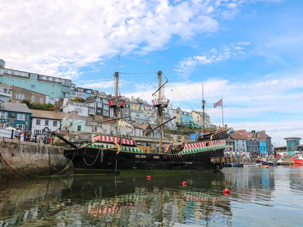 A ship docked in a harbor with buildings in the background at Bay View Brixham