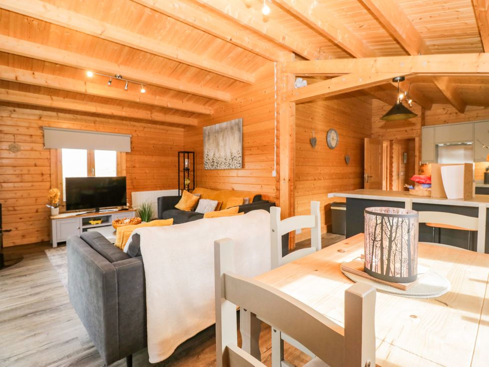 A living room with a sofa and a TV at Howgills Retreat Gatebeck near Kirkby Lonsdale