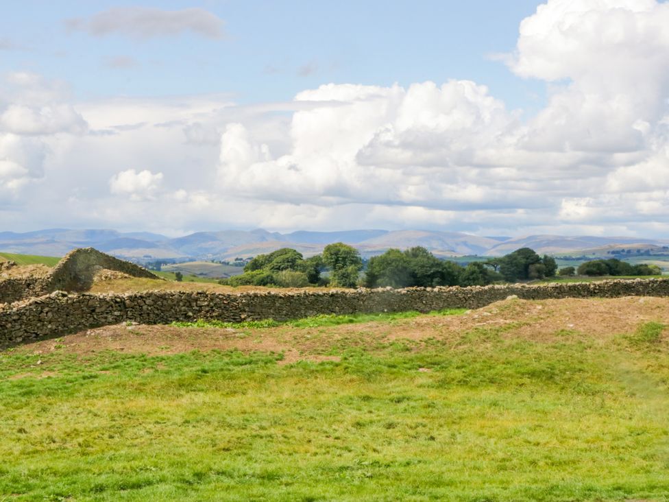 A landscape with stone wall and grass at Howgills Retreat Gatebeck near Kirkby Lonsdale