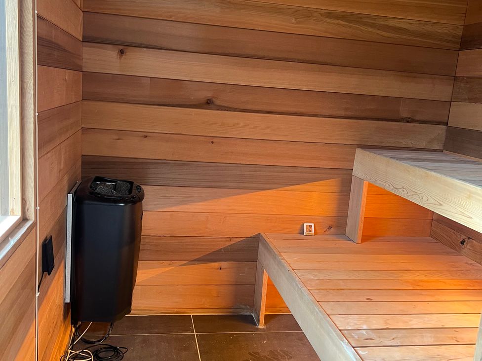 A sauna with wooden paneling and a bench at Spinners Cottage in East Morton
