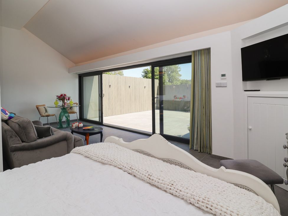A bedroom with a bed, sofa and access to outdoor area at Ninky Nonk in Bristol