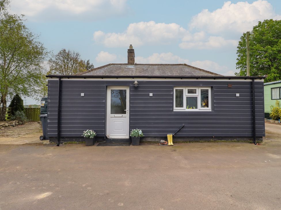 A front view of a house with a door and windows at Country Retreat in Ponteland