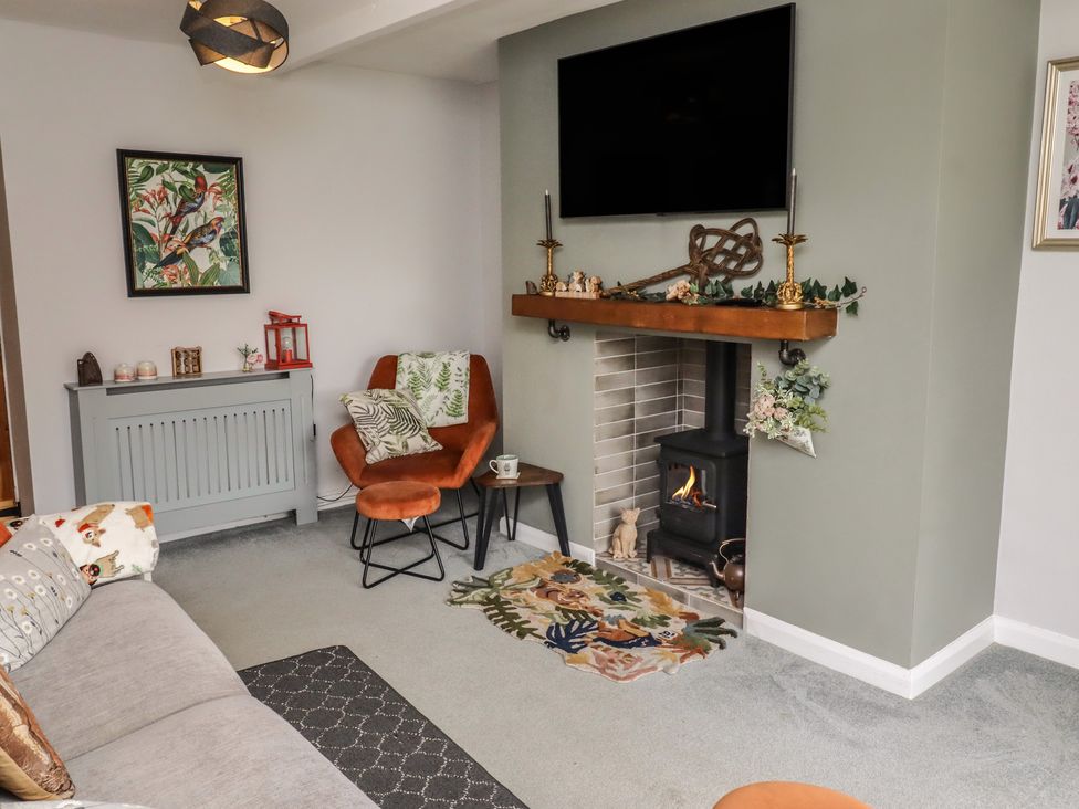 A living room with a fireplace and seating area at Country Retreat in Ponteland