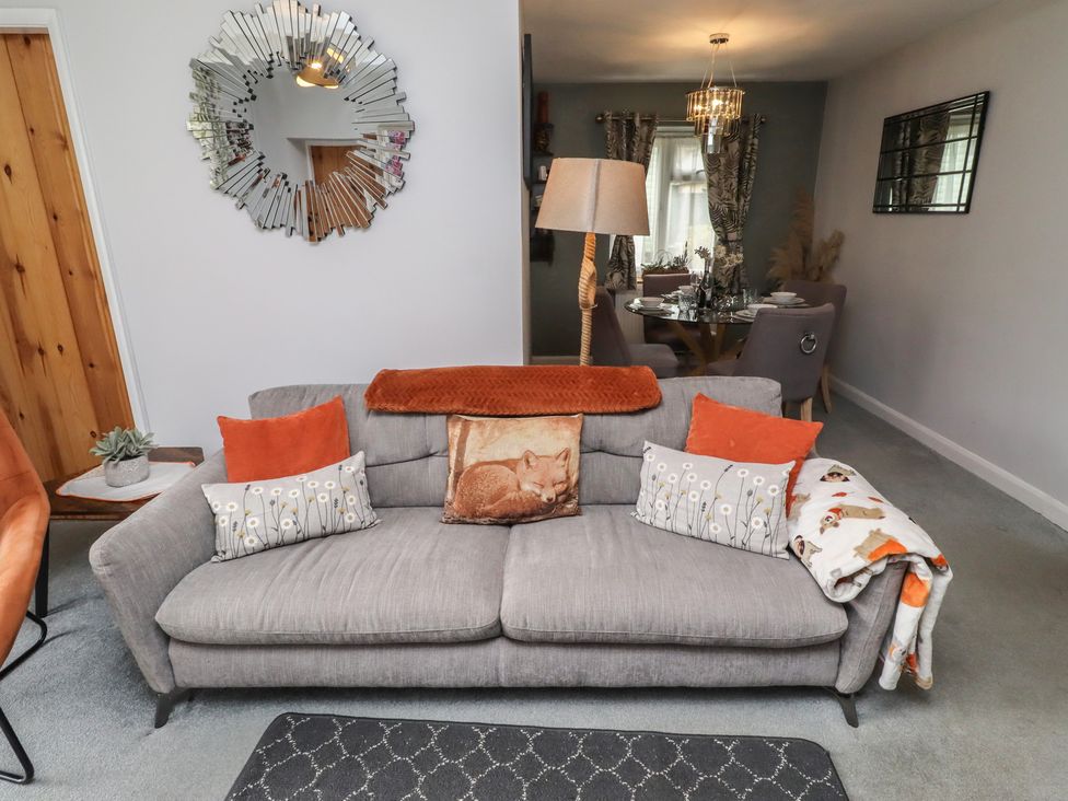 A living room with a sofa and dining area at Country Retreat in Ponteland