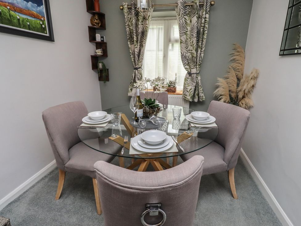 A dining room with a glass table and chairs at Country Retreat in Ponteland