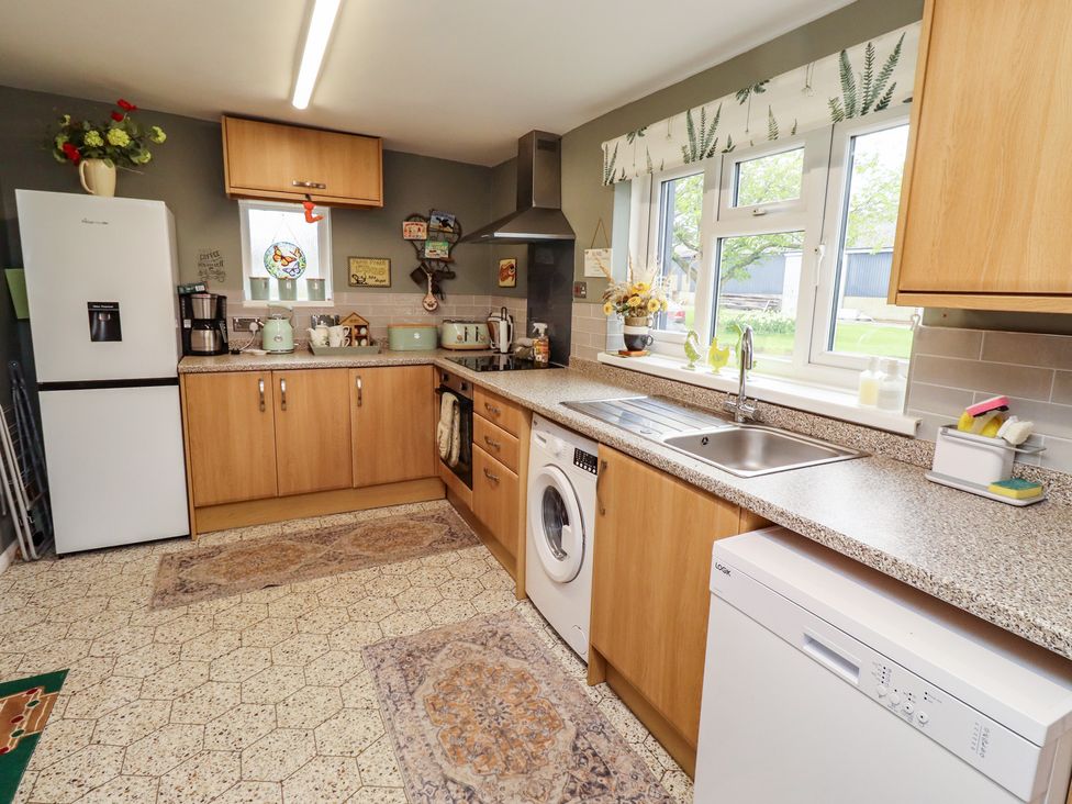A kitchen with cabinets and appliances at Country Retreat in Ponteland