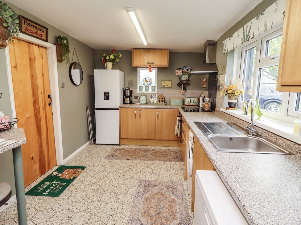 A kitchen with refrigerator and sink at Country Retreat in Ponteland