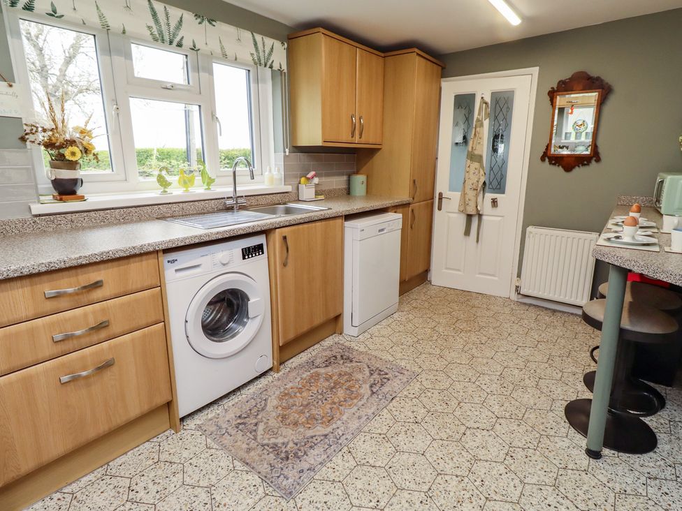 A kitchen with cabinets and appliances at Country Retreat in Ponteland