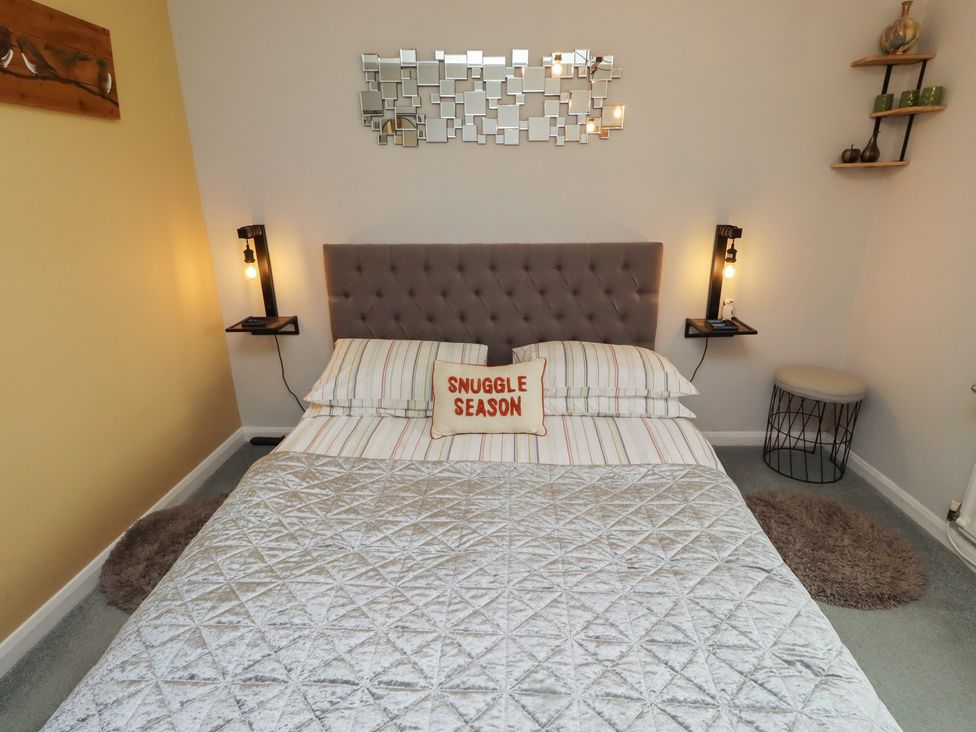 A bedroom with a bed and a nightstand at Country Retreat in Ponteland
