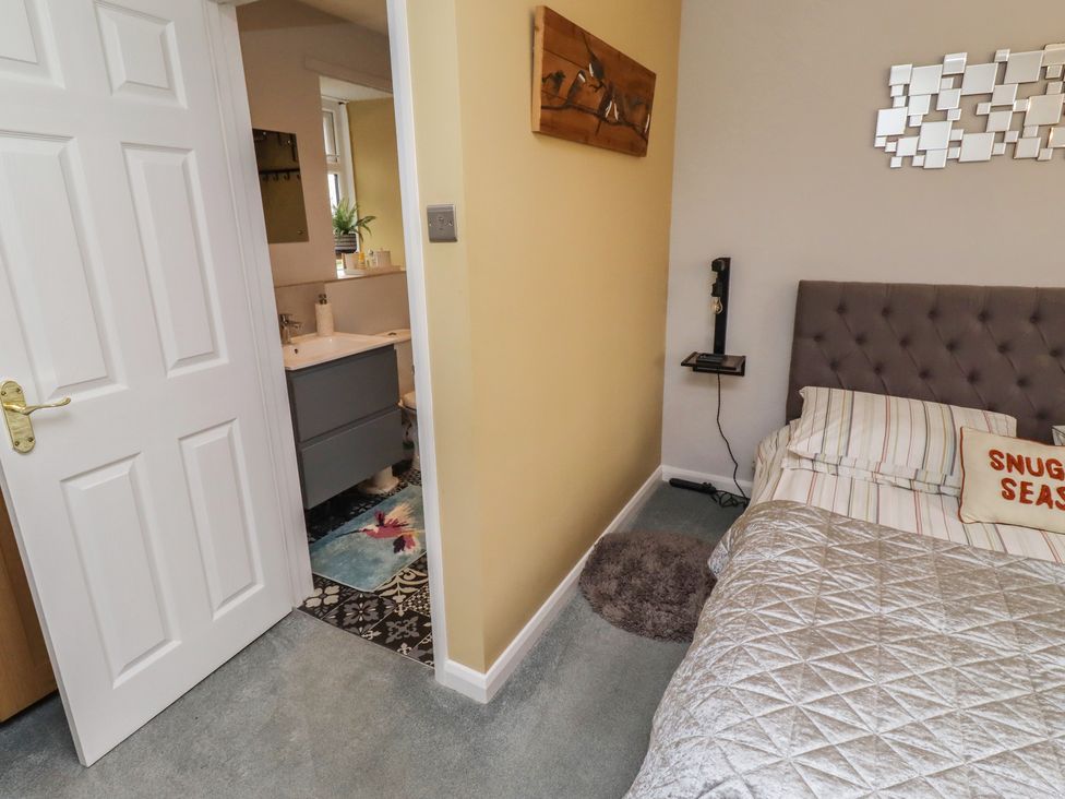 A bedroom with a bed and bedside table at Country Retreat in Ponteland