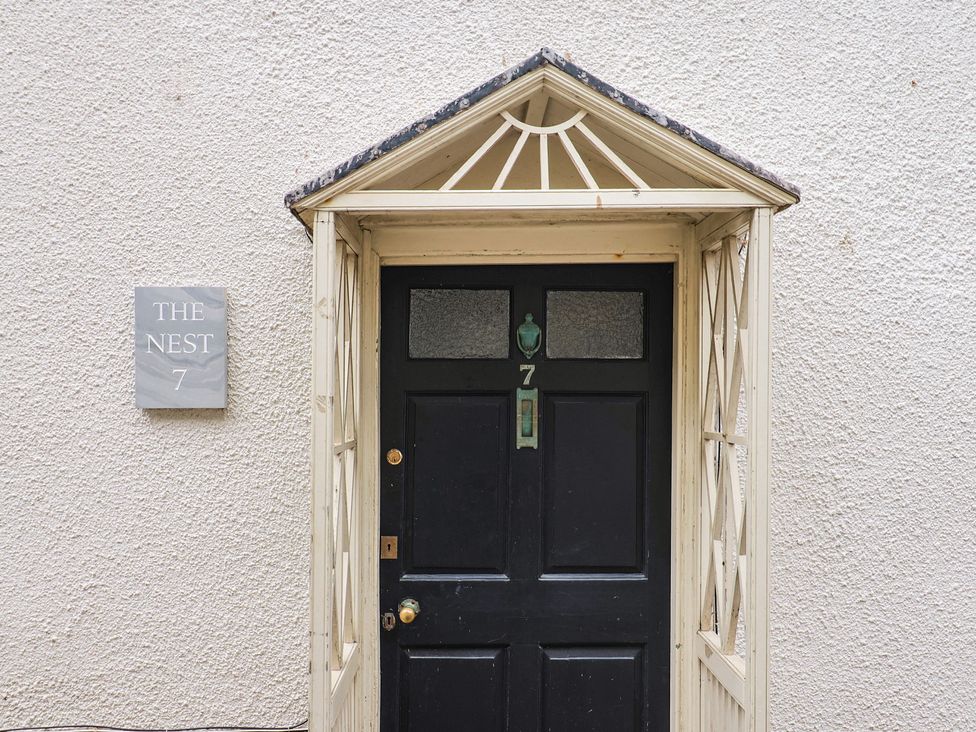 An entrance with a door and nameplate at The Nest in Lyme Regis