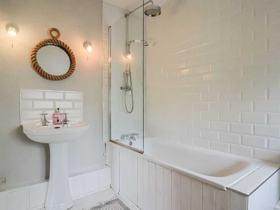 A bathroom with a sink and bathtub at The Nest in Lyme Regis