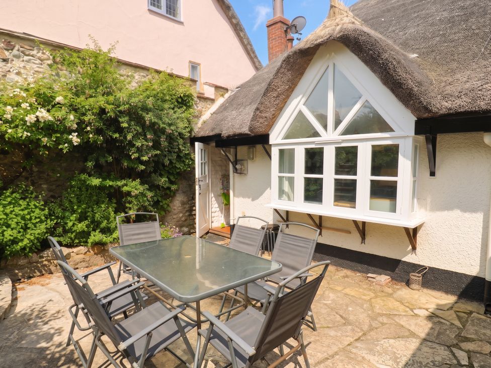 An outdoor area with a table and chairs at The Nest in Lyme Regis