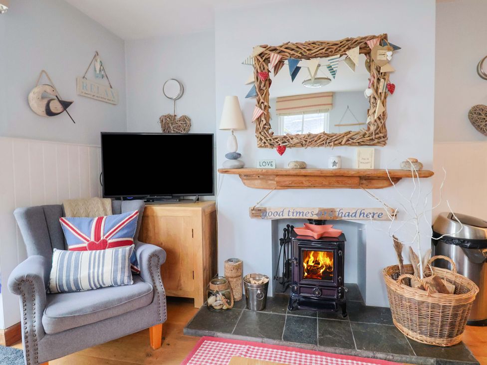 A living room with a fireplace and television at Seaside in Lyme Regis