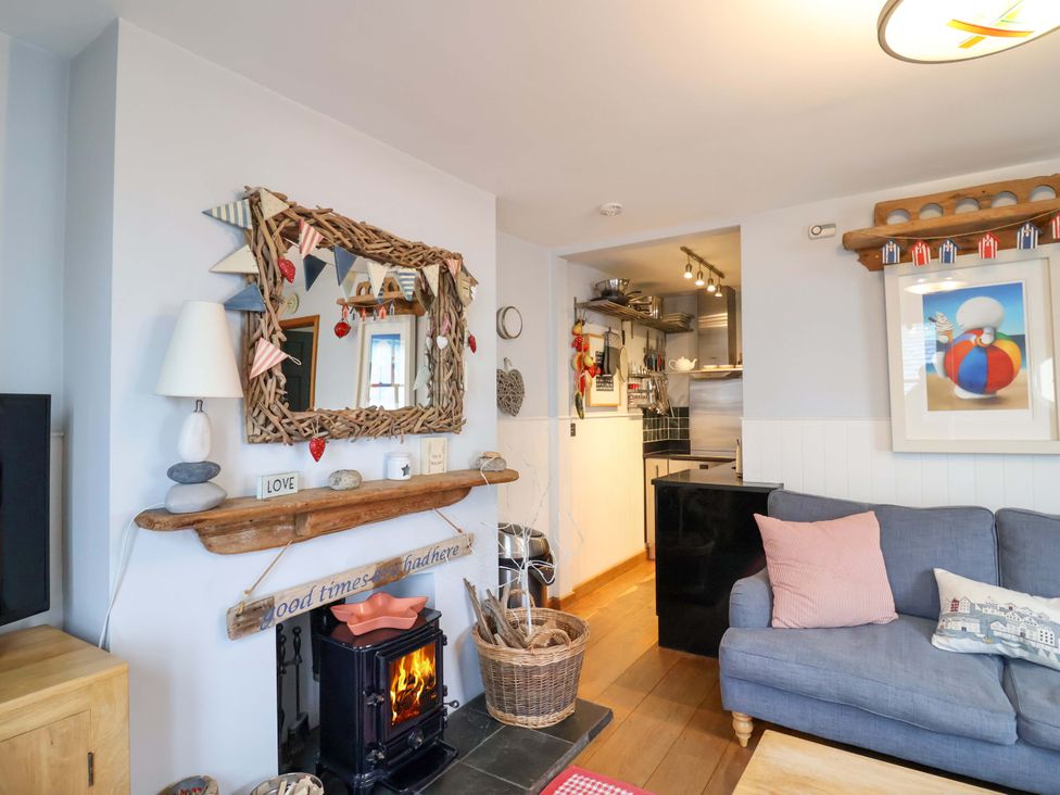 A living room with a sofa and a fireplace at Seaside in Lyme Regis