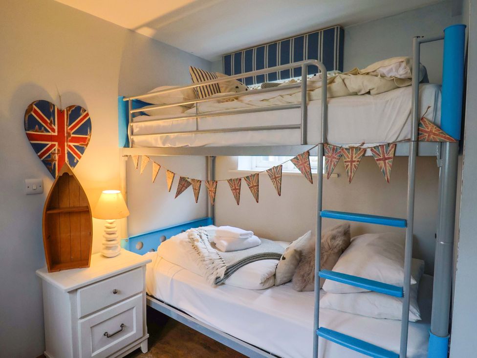 A bedroom with bunk bed and single bed at Seaside in Lyme Regis