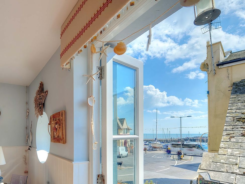A view from a window showing boats and a street at Seaside Lyme Regis