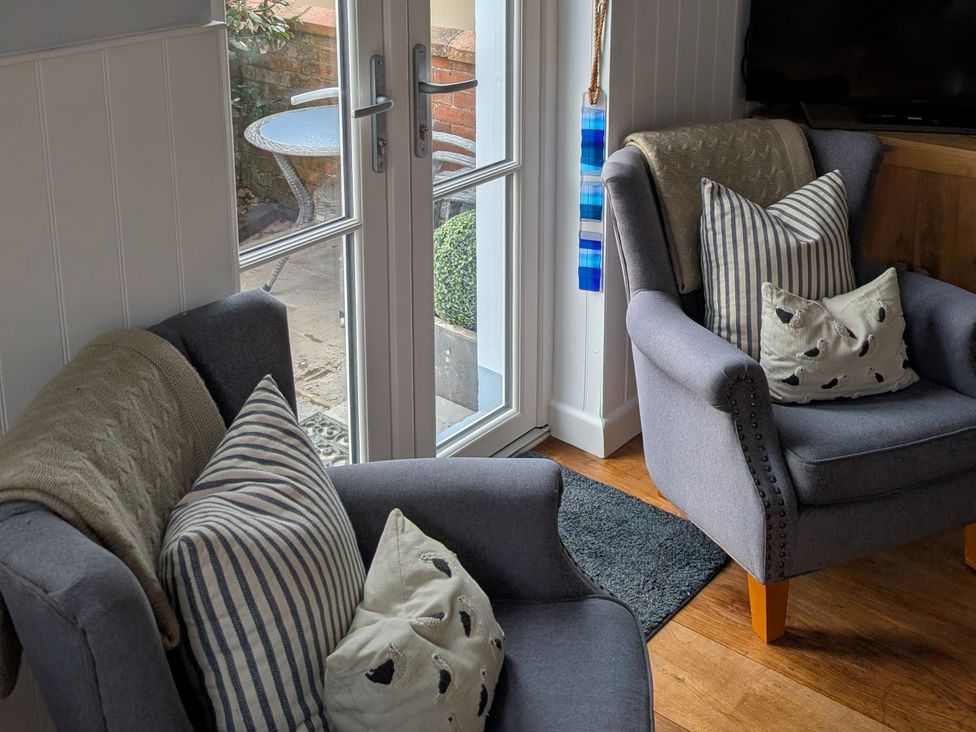A living room with two chairs and a table at Seaside in Lyme Regis
