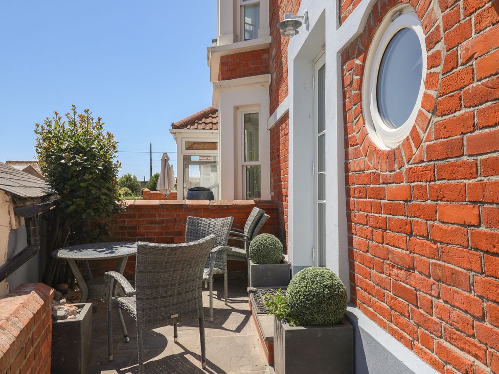An outdoor area with a table and chairs at Seaside in Lyme Regis