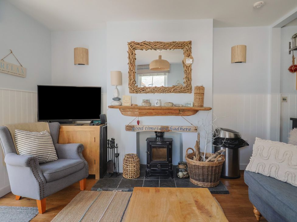 A living room with a television and a fireplace at Seaside in Lyme Regis