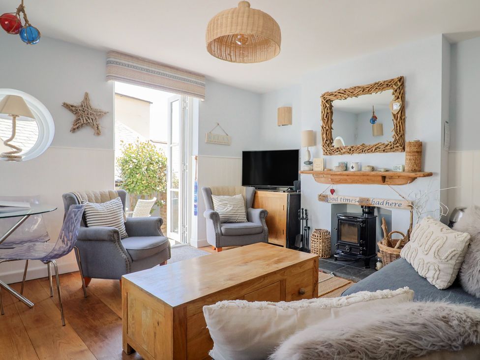 A living room with a fireplace and television at Seaside in Lyme Regis
