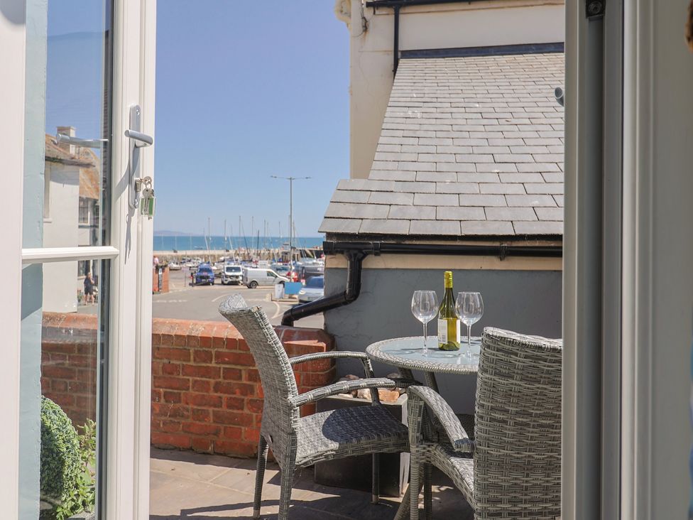 An outdoor sitting area with a table and chairs at Seaside in Lyme Regis
