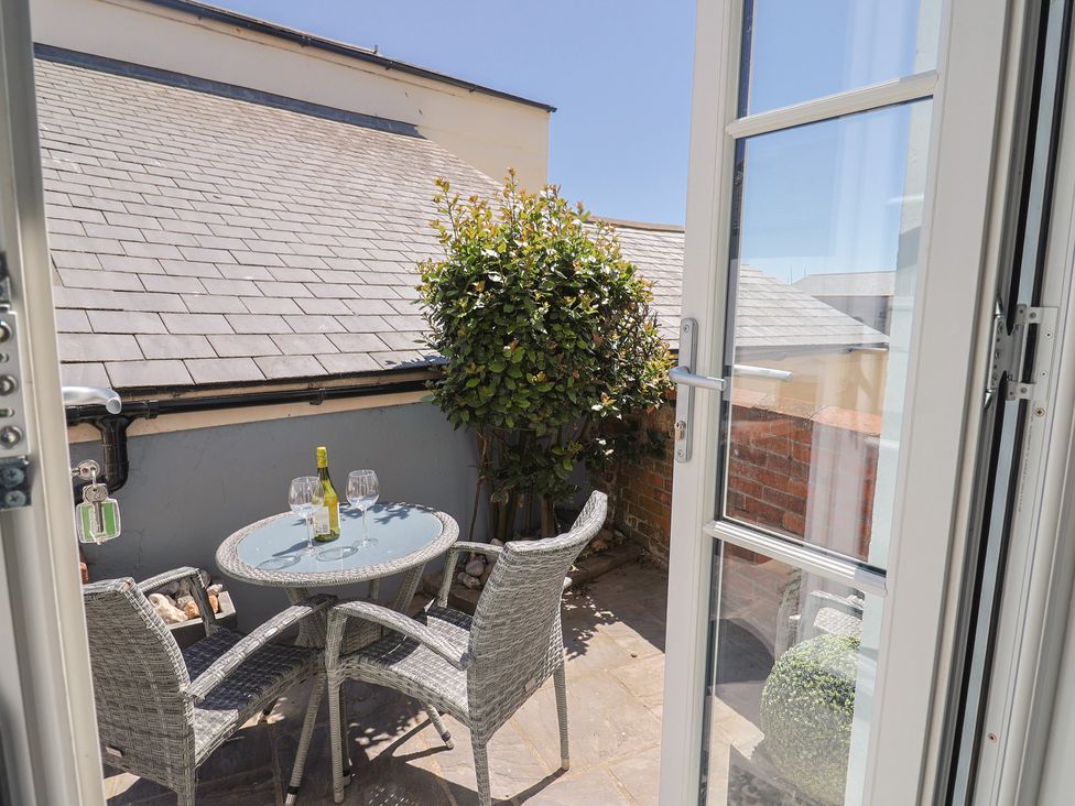 A balcony with a table and chairs at Seaside in Lyme Regis