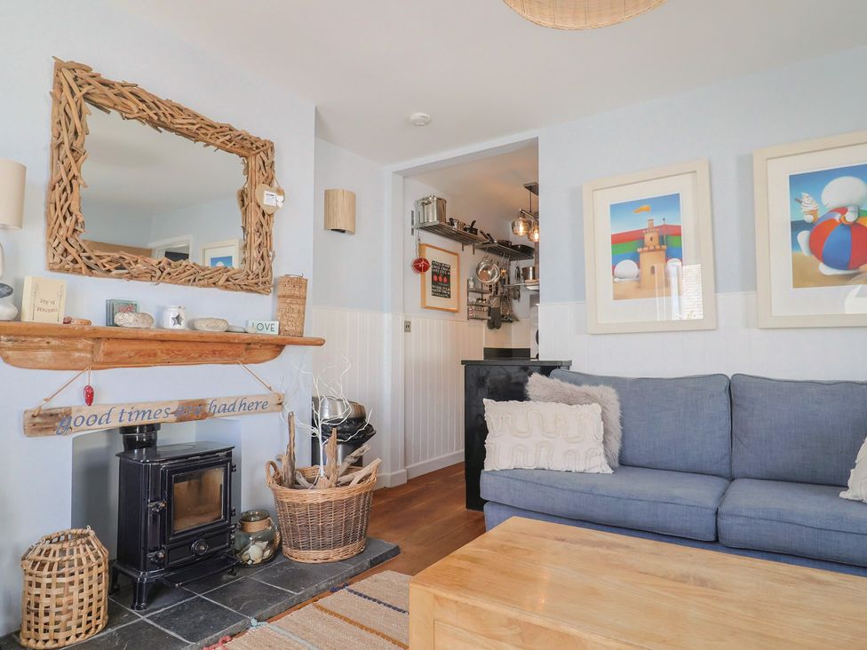 A living room with a fireplace and couch at Seaside in Lyme Regis