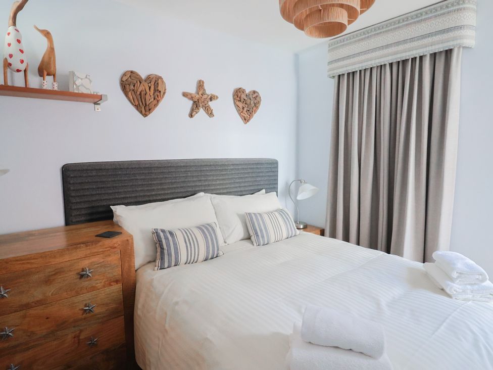 A bedroom with a bed and decorative items at Seaside in Lyme Regis
