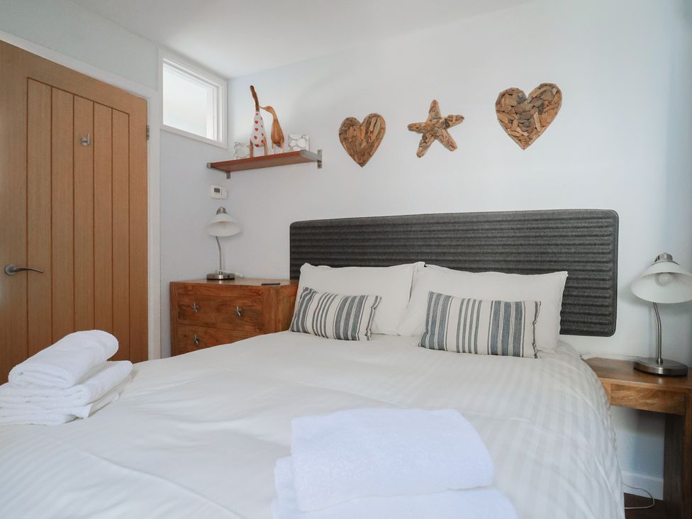A bedroom with a bed and bedside table at Seaside in Lyme Regis