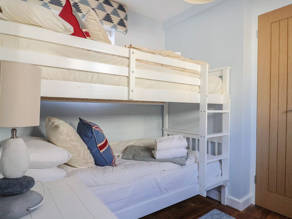 A bedroom with a bunk bed and pillows at Seaside in Lyme Regis