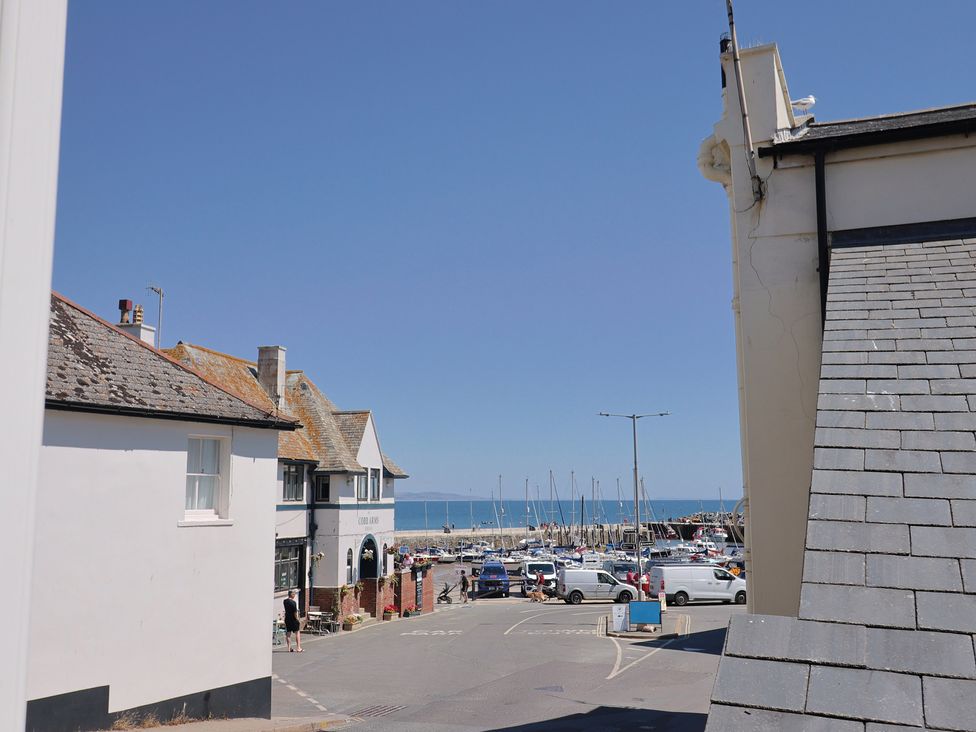 A street view of buildings and boats at Seaside in Lyme Regis
