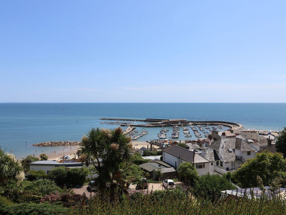 A view of the beach and harbor at Seaside in Lyme Regis