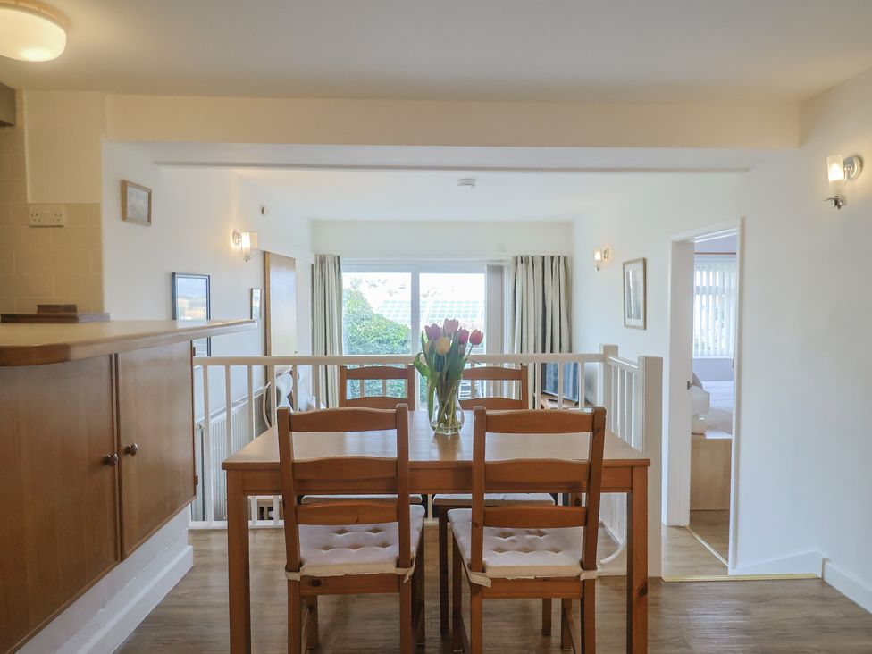A dining room with a table and chairs at Greystones Flat in Lyme Regis