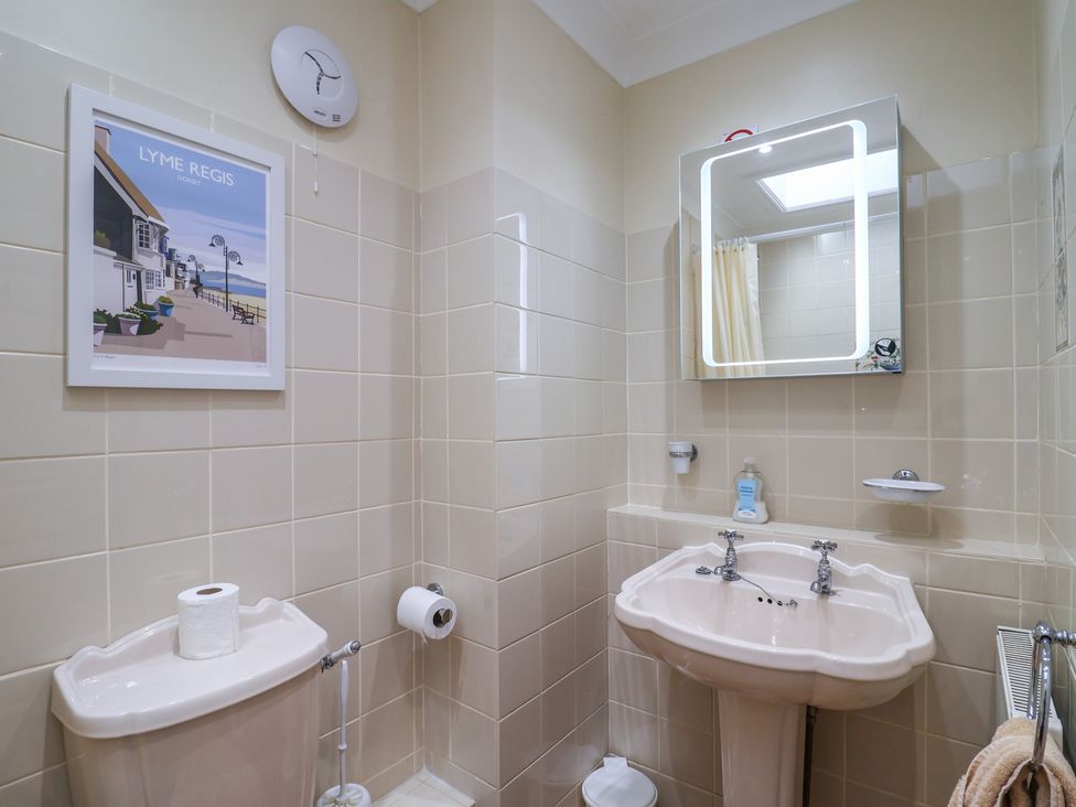 A bathroom with a toilet and sink at Blacksmiths Cottage Lyme Regis
