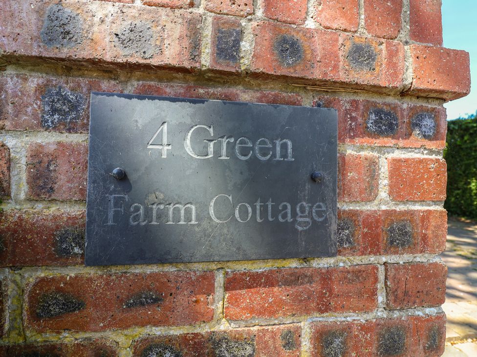 A nameplate on a brick wall at 4 Green Farm Cottage Saughall