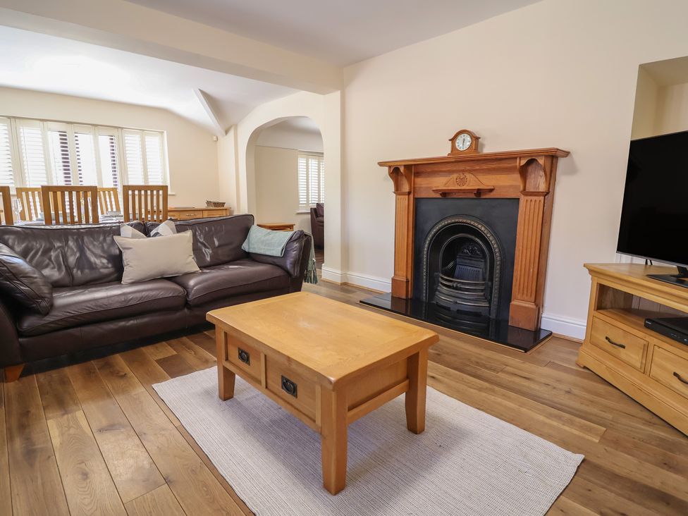 A living room with a sofa and fireplace at 4 Green Farm Cottage Saughall