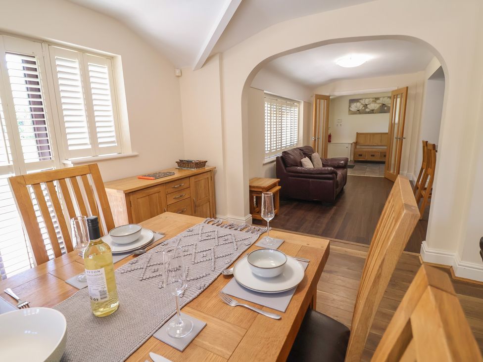 A dining room with a table set for dinner at 4 Green Farm Cottage Saughall