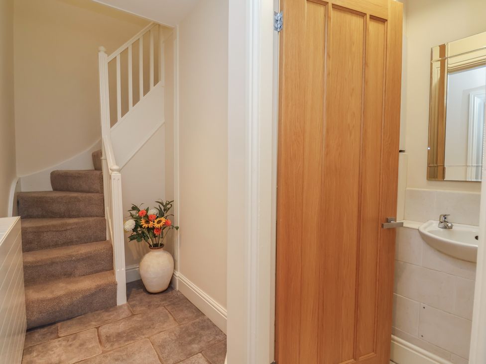 A hallway with a staircase and a toilet in 4 Green Farm Cottage Saughall