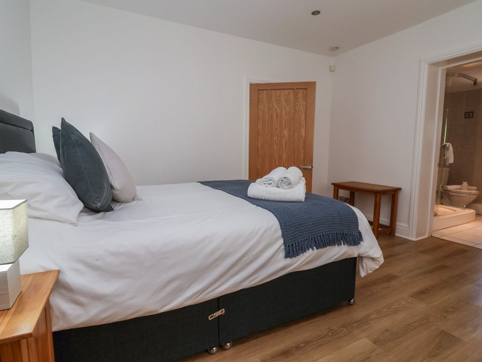 A bedroom with a bed and lamp at 4 Green Farm Cottage in Saughall
