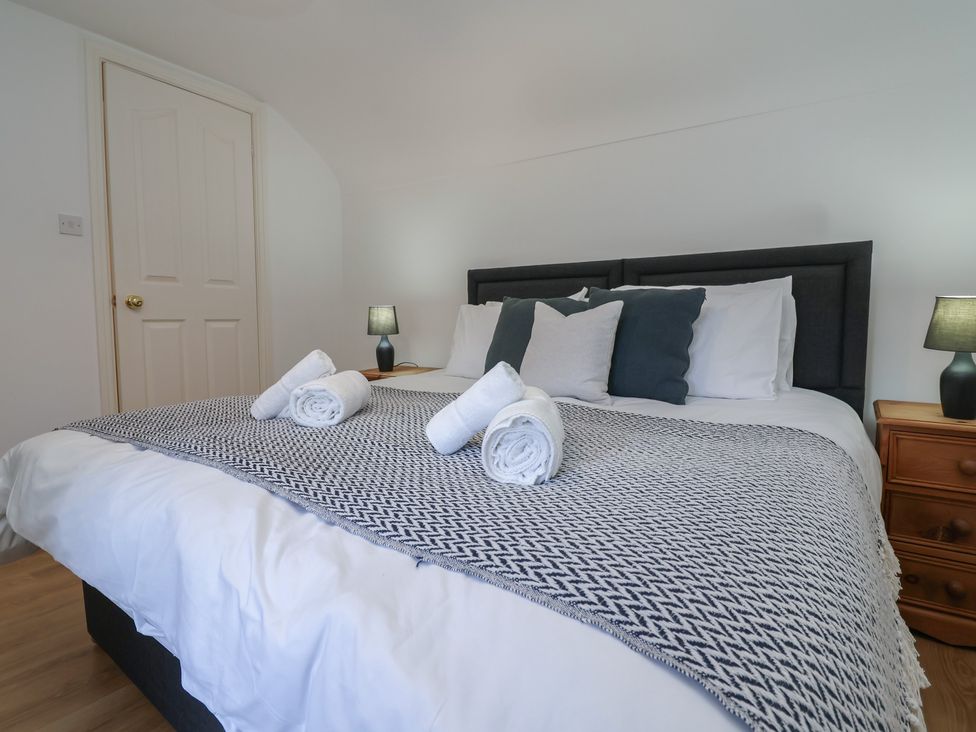 A bedroom with a bed and pillows at 4 Green Farm Cottage Saughall