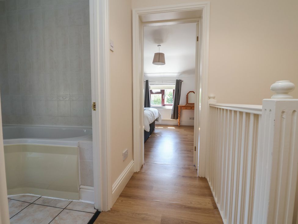 A hallway leading to a bedroom and bathroom at 4 Green Farm Cottage Saughall
