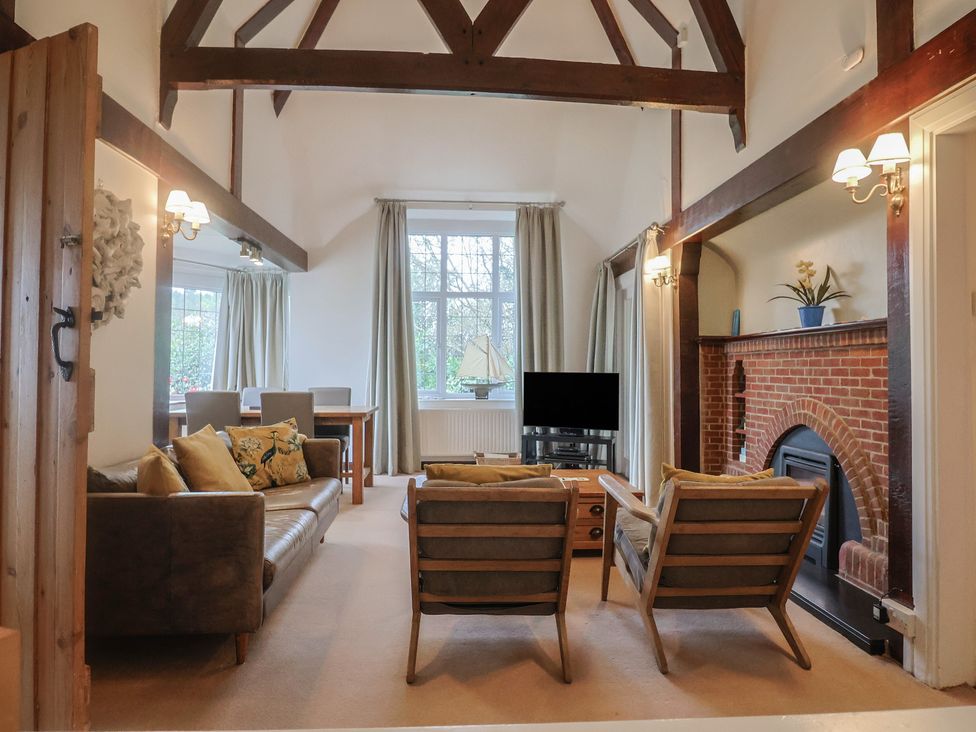 A living room with sofa and armchairs at Maries in Lyme Regis