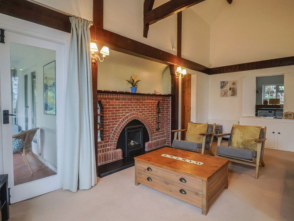 A living room with a fireplace and seating at Maries in Lyme Regis