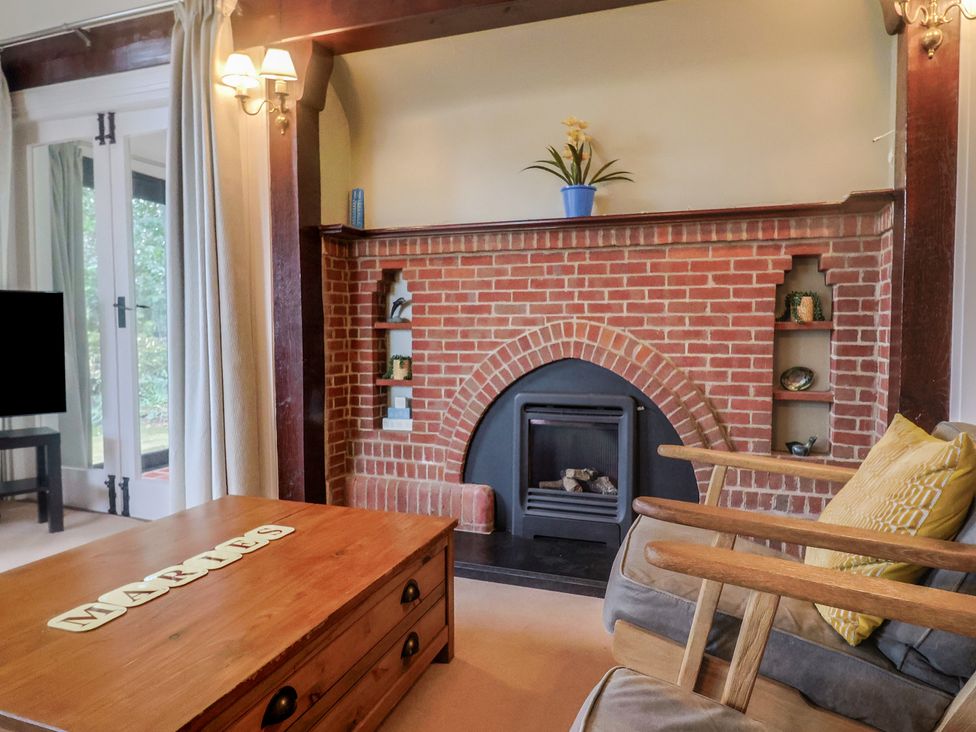 A living room with a fireplace and TV at Maries in Lyme Regis