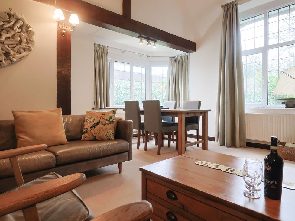 A living room with a sofa and dining area at Maries in Lyme Regis