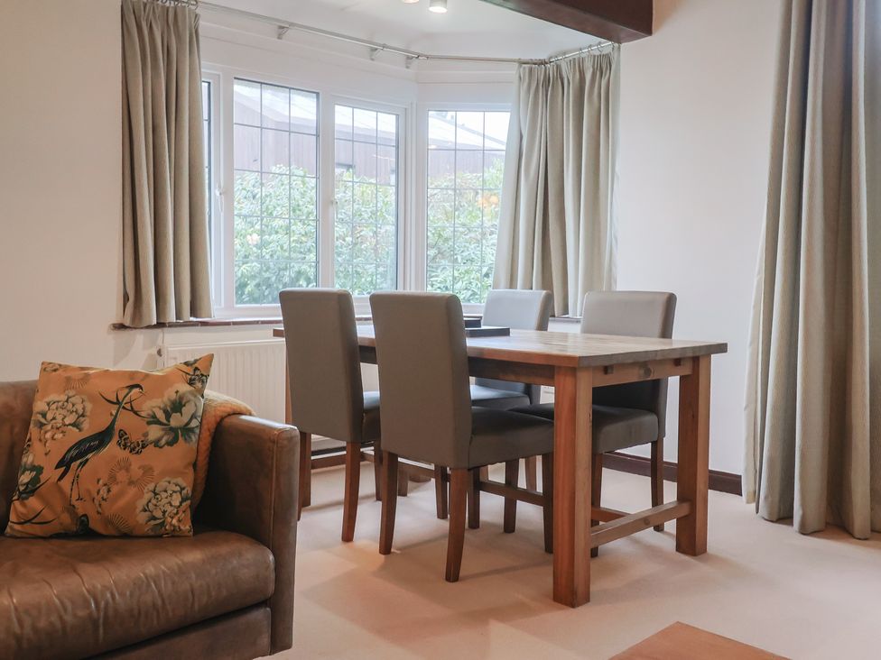 A dining room with a table and chairs at Maries in Lyme Regis